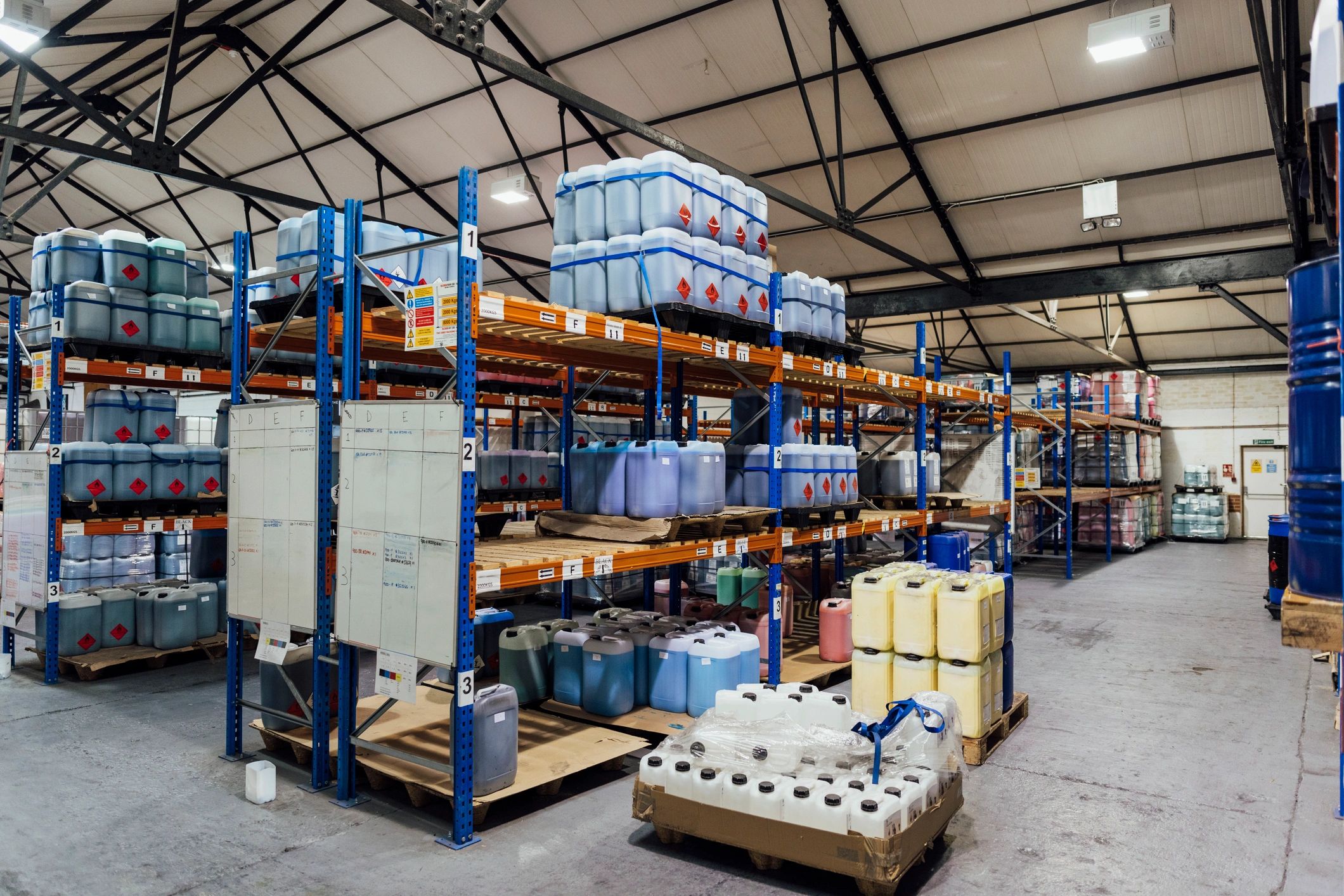 Industrial warehouse shelving with chemical containers