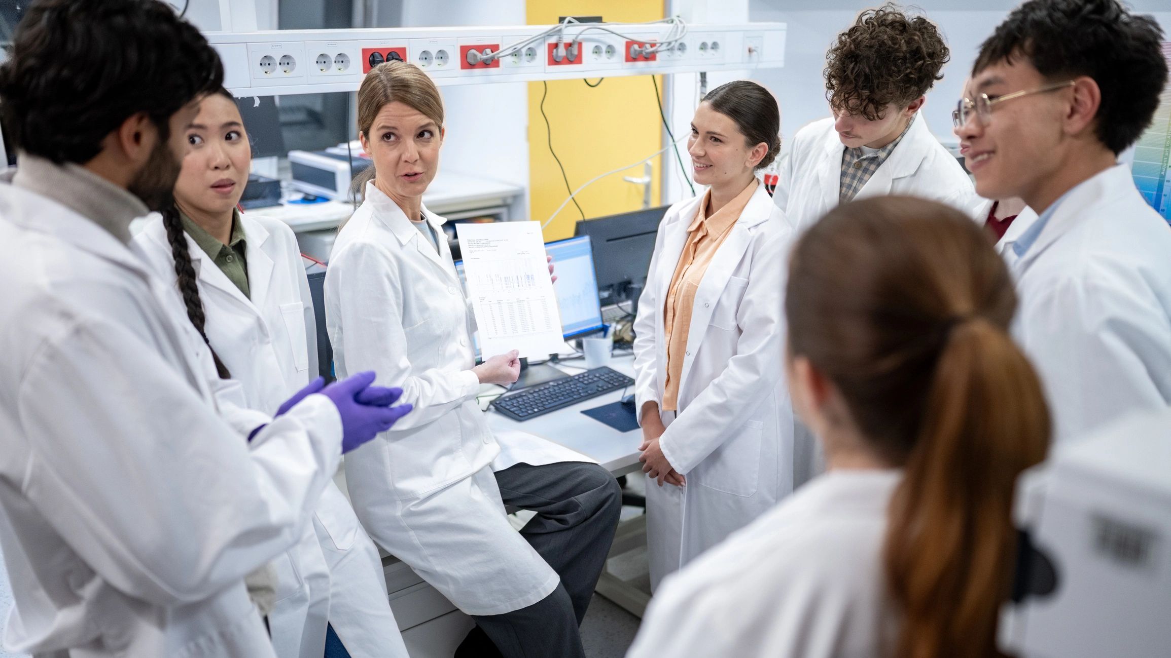Chemical distribution team collaborating in a laboratory environment